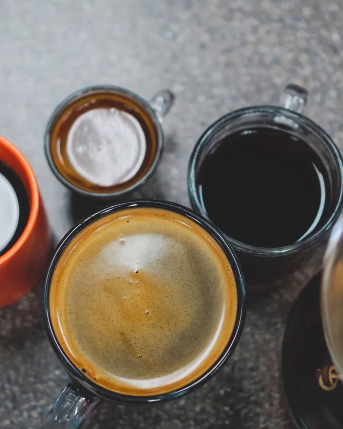 Verschillende koppen koffie naast elkaar, van bovenaf